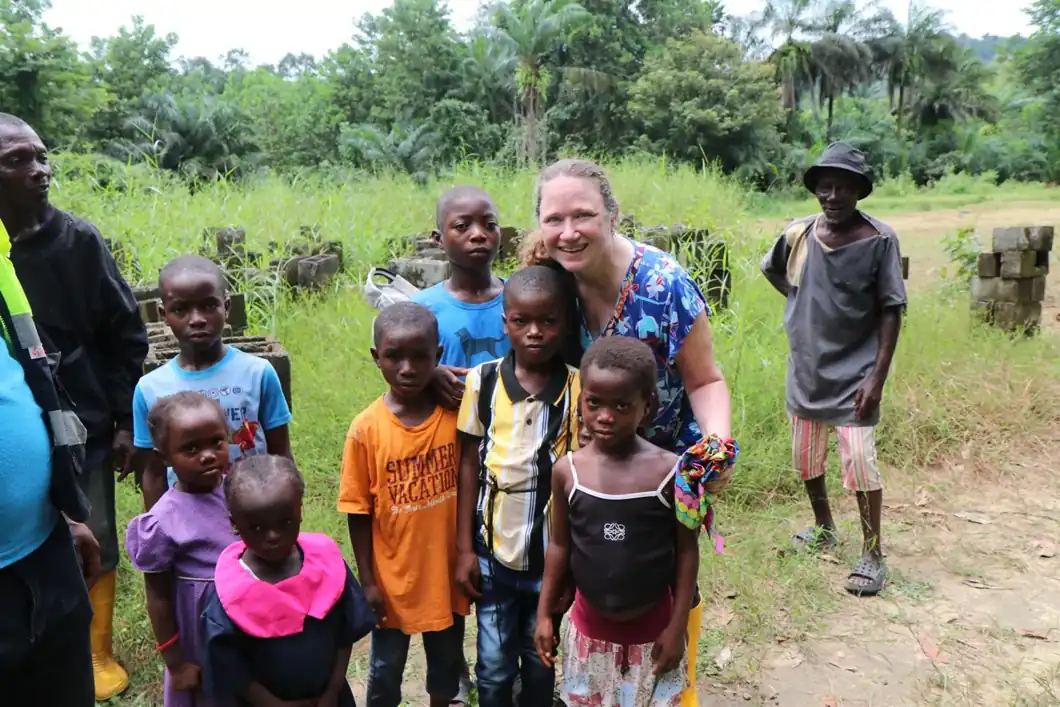 Children and a visitor gathered outdoors